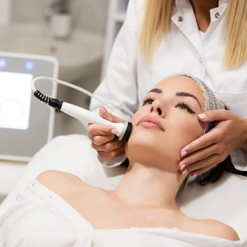 Beautiful woman in professional beauty salon during photo rejuvenation procedure